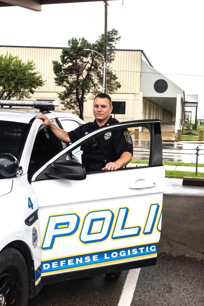 Police Sergeant Novak next to police car